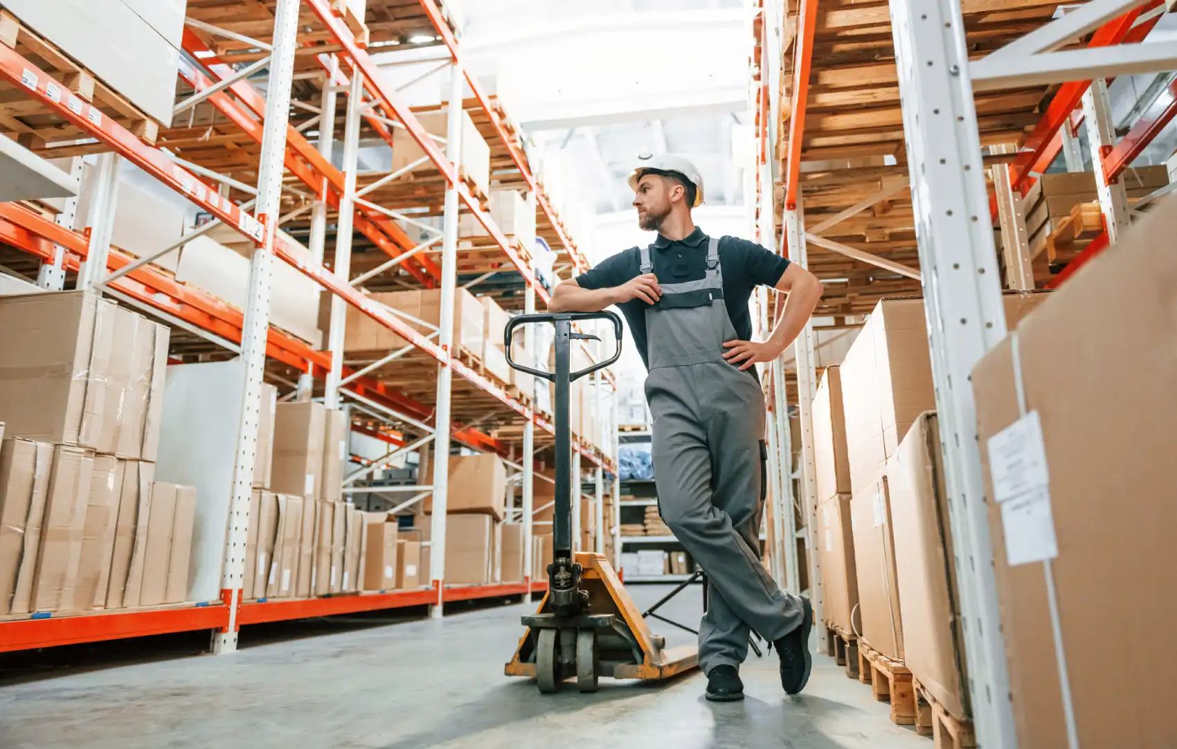 Warehouse Employee With Pallet Jack Looks At Stora 2026 03 24 04 40 29 Utc